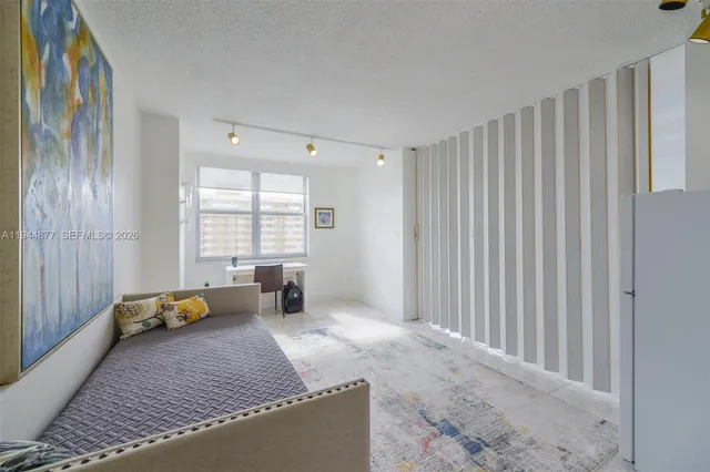 a spacious bedroom with a bed and a cabinets