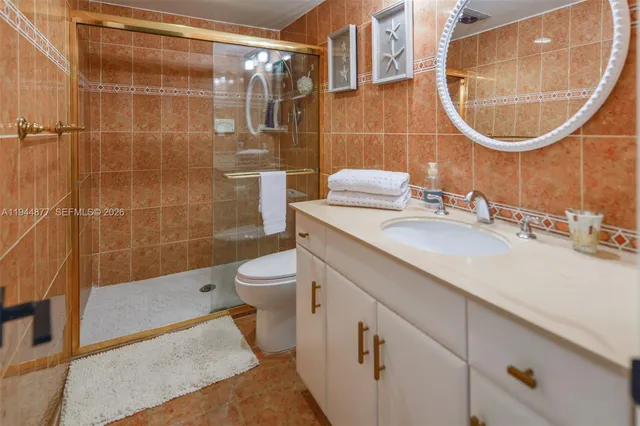 a bathroom with a sink mirror toilet and bathtub