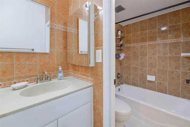 a bedroom with two beds and a couch