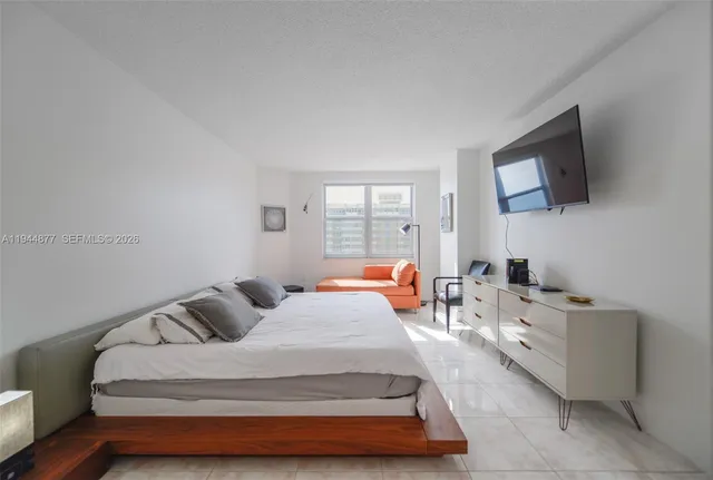 a bathroom with a granite countertop sink mirror and a shower