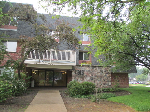918 Ridge Square, Unit 205 Elk Grove Village, IL 60007 - Photo 1 of 7 a front view of a house with a garden