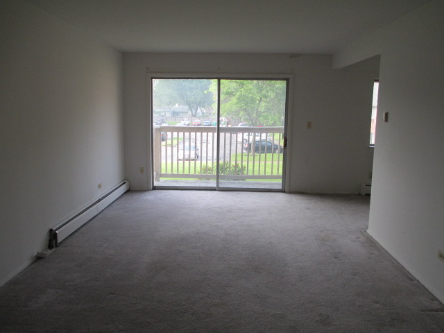 918 Ridge Square, Unit 205 Elk Grove Village, IL 60007 - Photo 2 of 7 a view of an empty room with a window