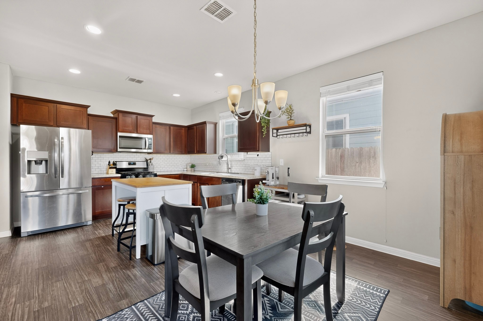 132 Wapiti Road Buda, TX 78610 - Photo 4 of 31 Culinary delights await in this bright kitchen with rich cabinetry and an adjacent dining area.