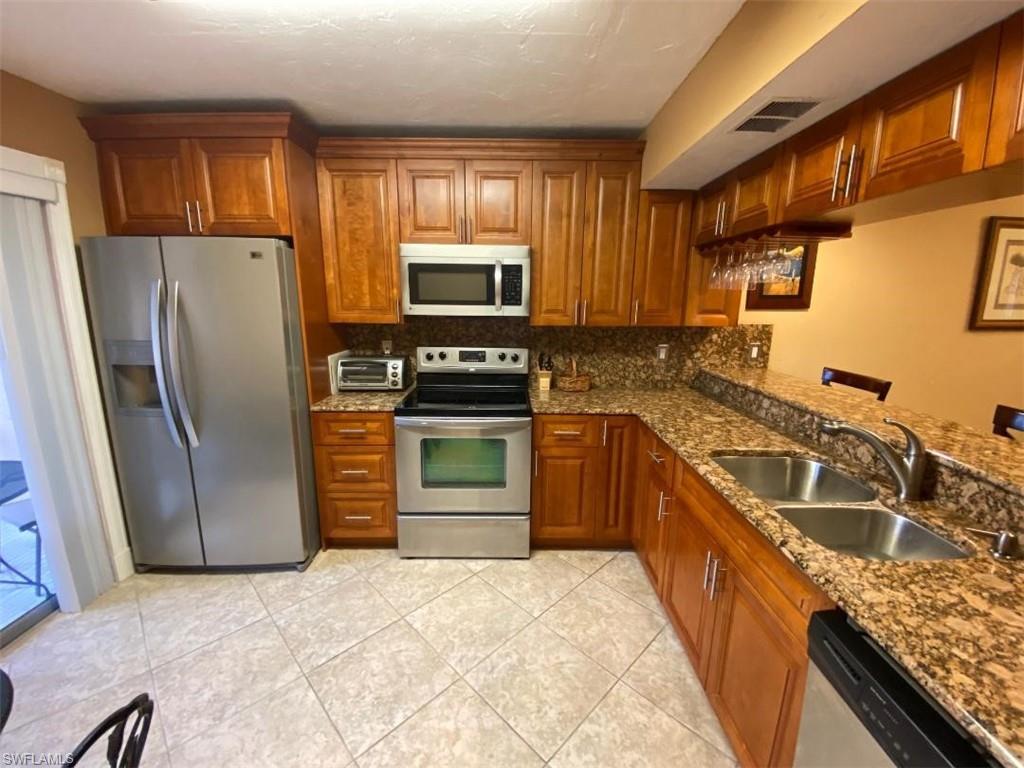 a kitchen with a refrigerator sink and microwave