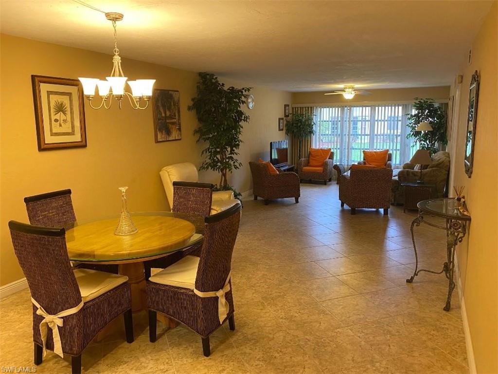 4031 Ice Castle Way, Unit 3303 Naples, FL 34112 - Photo 4 of 18 a living room with furniture and wooden floor