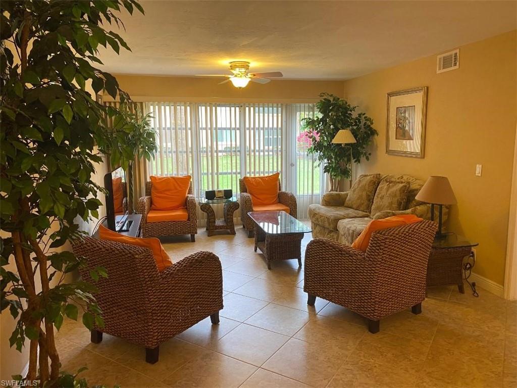 4031 Ice Castle Way, Unit 3303 Naples, FL 34112 - Photo 5 of 18 a living room with furniture and a large window