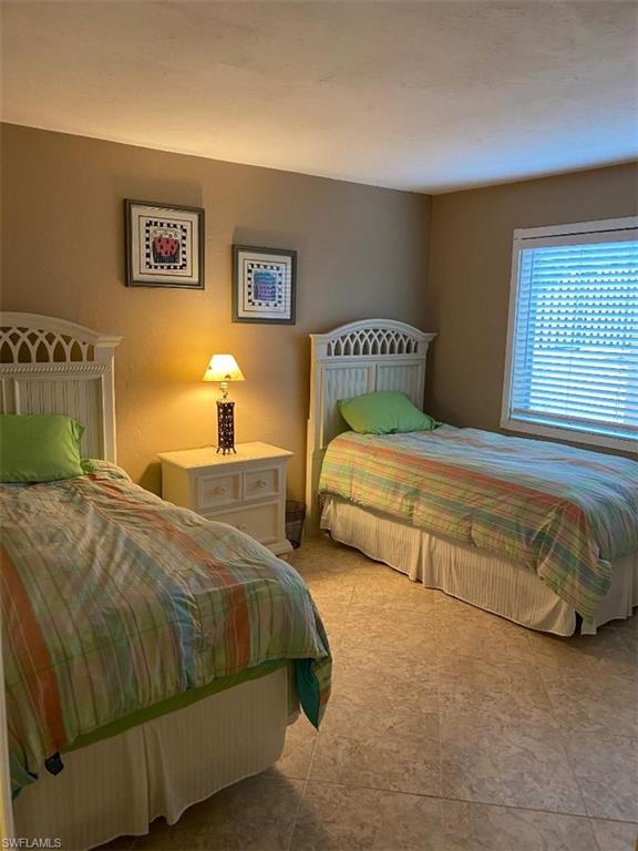 4031 Ice Castle Way, Unit 3303 Naples, FL 34112 - Photo 9 of 18 a bedroom with two beds and painting on the wall
