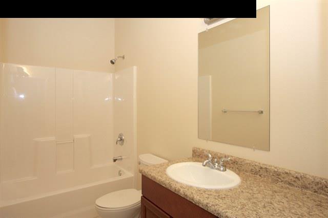 11 Maha Road, Unit 11 Makawao, HI 96768 - Photo 12 of 20 a bathroom with a granite countertop sink toilet and shower