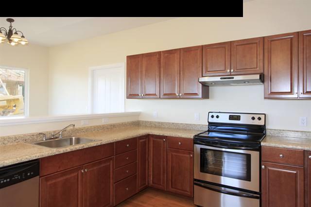 11 Maha Road, Unit 11 Makawao, HI 96768 - Photo 5 of 20 a kitchen with granite countertop a stove and a sink