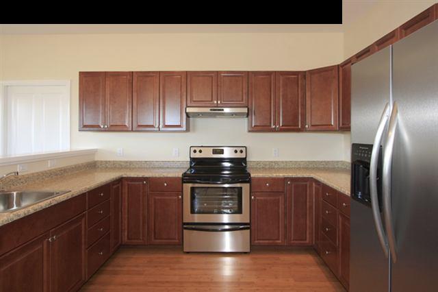 11 Maha Road, Unit 11 Makawao, HI 96768 - Photo 7 of 20 a kitchen with stainless steel appliances granite countertop a stove and a refrigerator