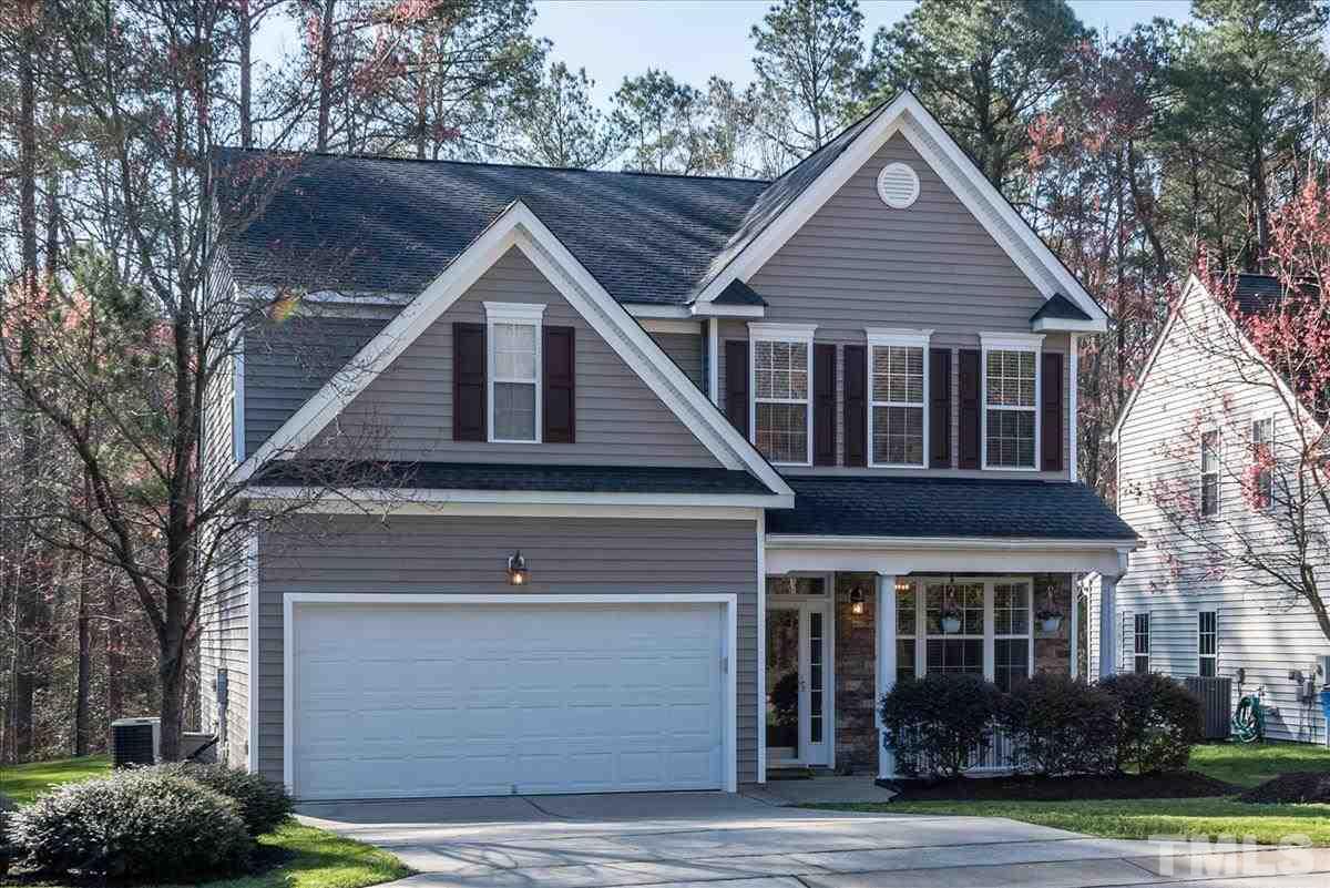 7724 Braefield Drive Raleigh, NC 27616 - Photo 2 of 27 a front view of a house with garden