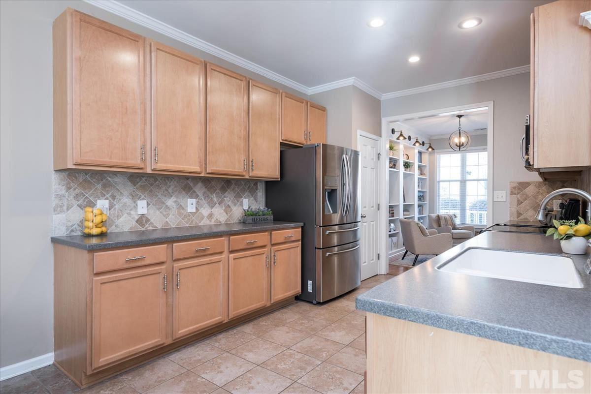 7724 Braefield Drive Raleigh, NC 27616 - Photo 11 of 27 a kitchen with stainless steel appliances granite countertop a sink a refrigerator and a granite counter tops