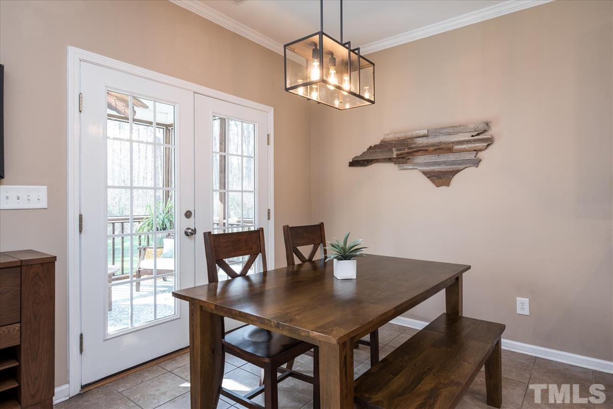 7724 Braefield Drive Raleigh, NC 27616 - Photo 12 of 27 a view of a dining room with a table and chairs