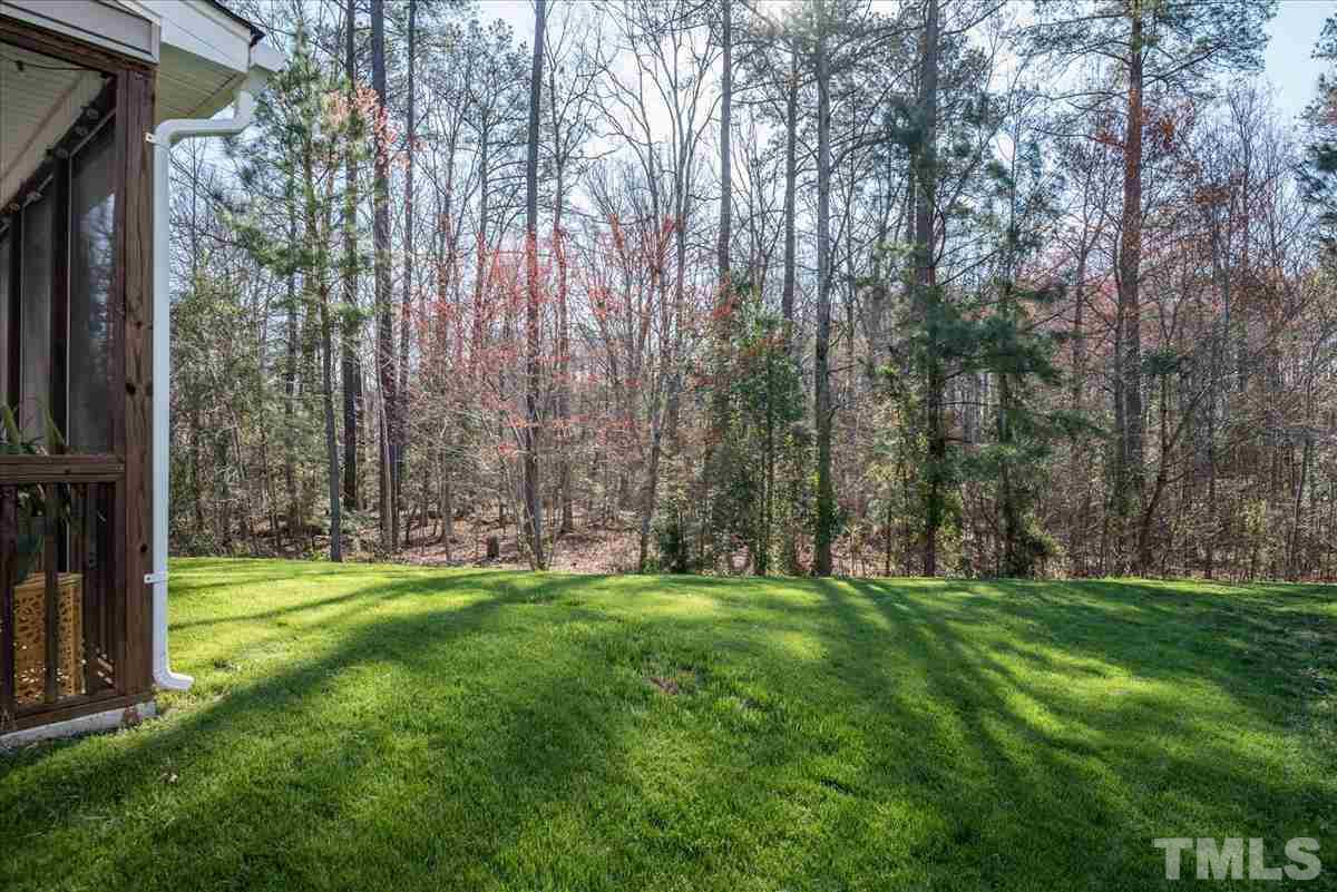 7724 Braefield Drive Raleigh, NC 27616 - Photo 27 of 27 a backyard of apartments with large trees