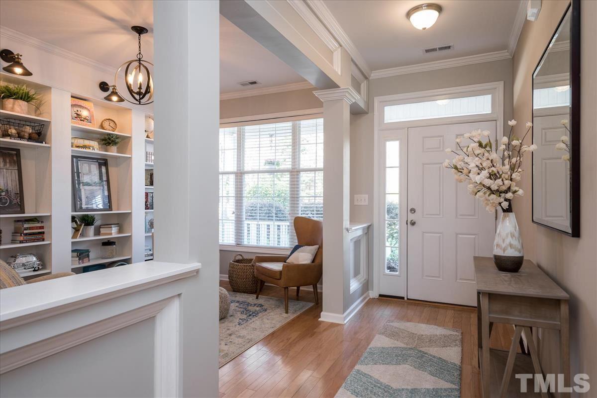 7724 Braefield Drive Raleigh, NC 27616 - Photo 5 of 27 a living room with furniture a flat screen tv and a window