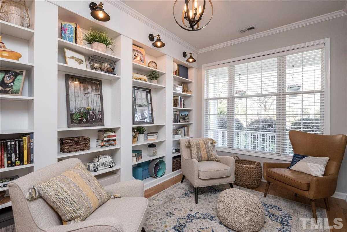 7724 Braefield Drive Raleigh, NC 27616 - Photo 6 of 27 a living room with furniture and a large window