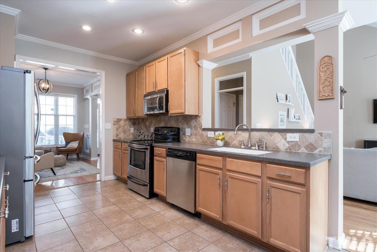 7724 Braefield Drive Raleigh, NC 27616 - Photo 10 of 27 a kitchen with a sink cabinets and window