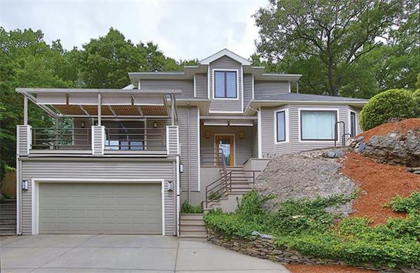 25 Risley Road Brookline, MA 02467 - Photo 1 of 1 a front view of a house with a garden