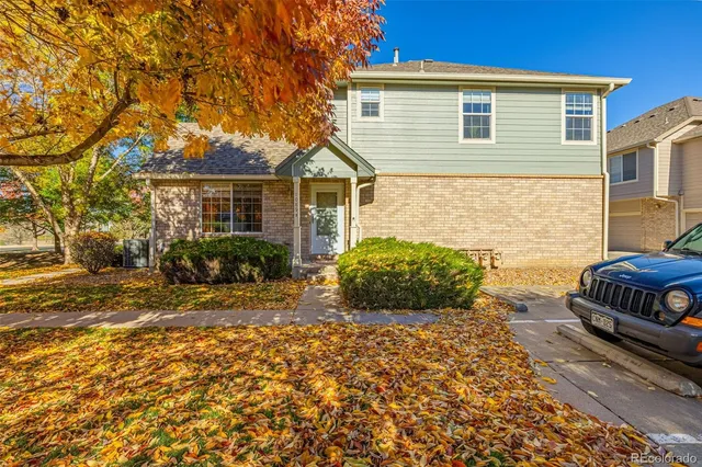 a front view of a house with a large trees