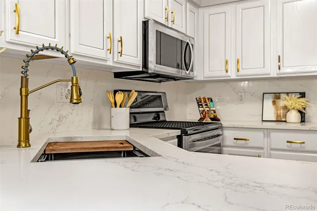 a kitchen with stainless steel appliances granite countertop a sink and cabinets