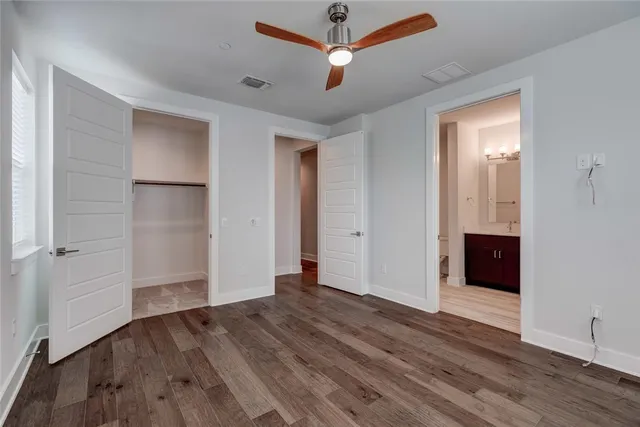 a bathroom with a double vanity sink toilet and a mirror