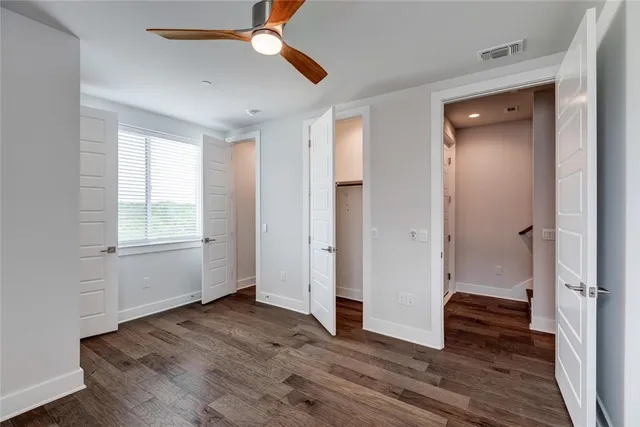 a view of a room with wooden floor and stairs
