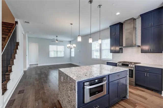 a kitchen with stainless steel appliances granite countertop wooden cabinets stove a sink and dishwasher