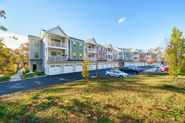 a view of swimming pool with outdoor seating and covered with trees