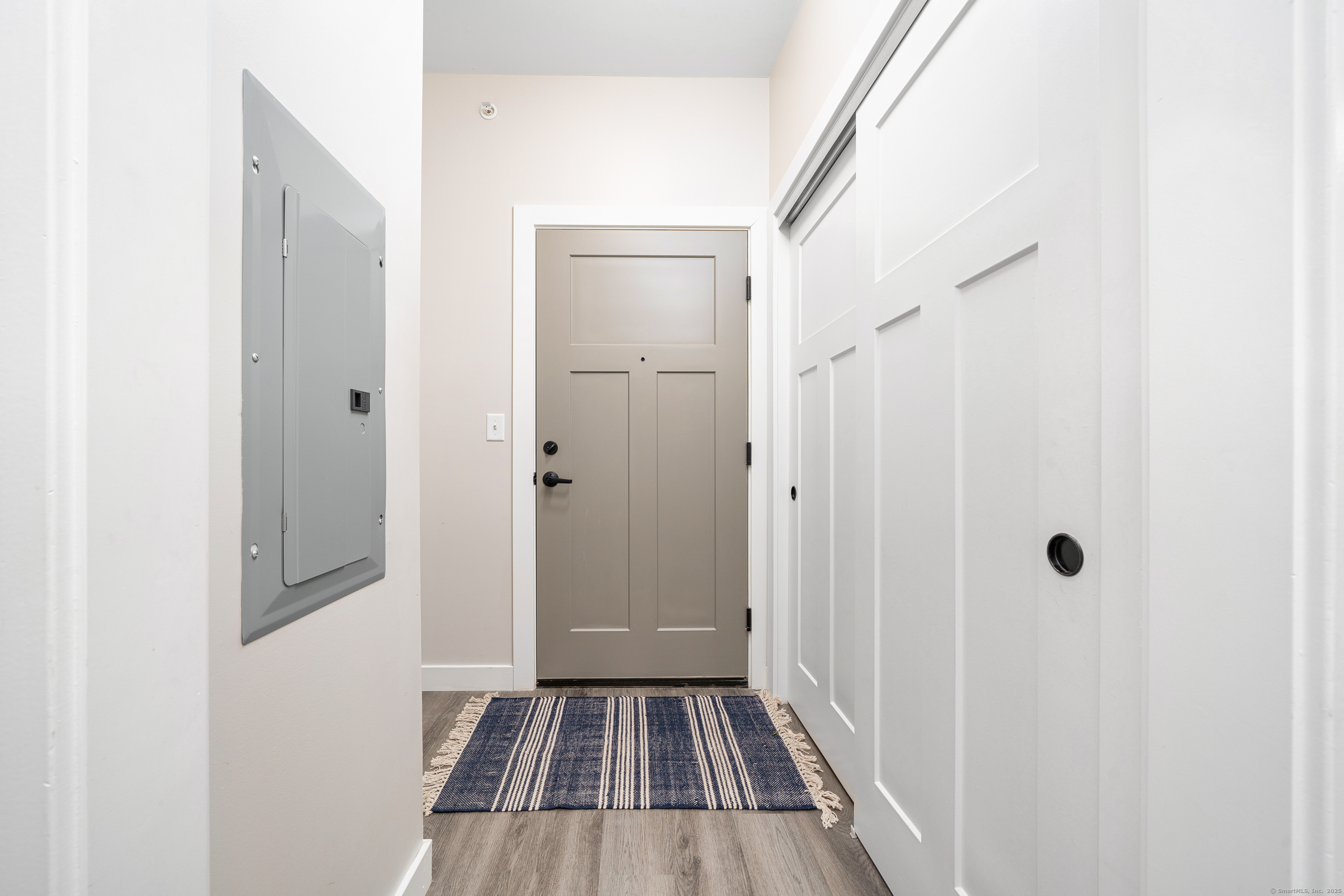 401 Albany Turnpike, Unit 201 Canton, CT 06019 - Photo 11 of 22 a view of a hallway with wooden floor and a bathroom
