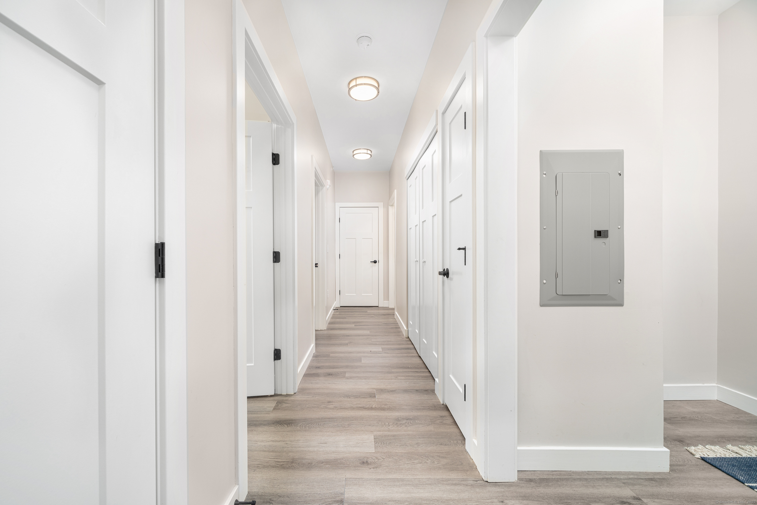 401 Albany Turnpike, Unit 201 Canton, CT 06019 - Photo 12 of 22 a view of a hallway with wooden floor and staircase
