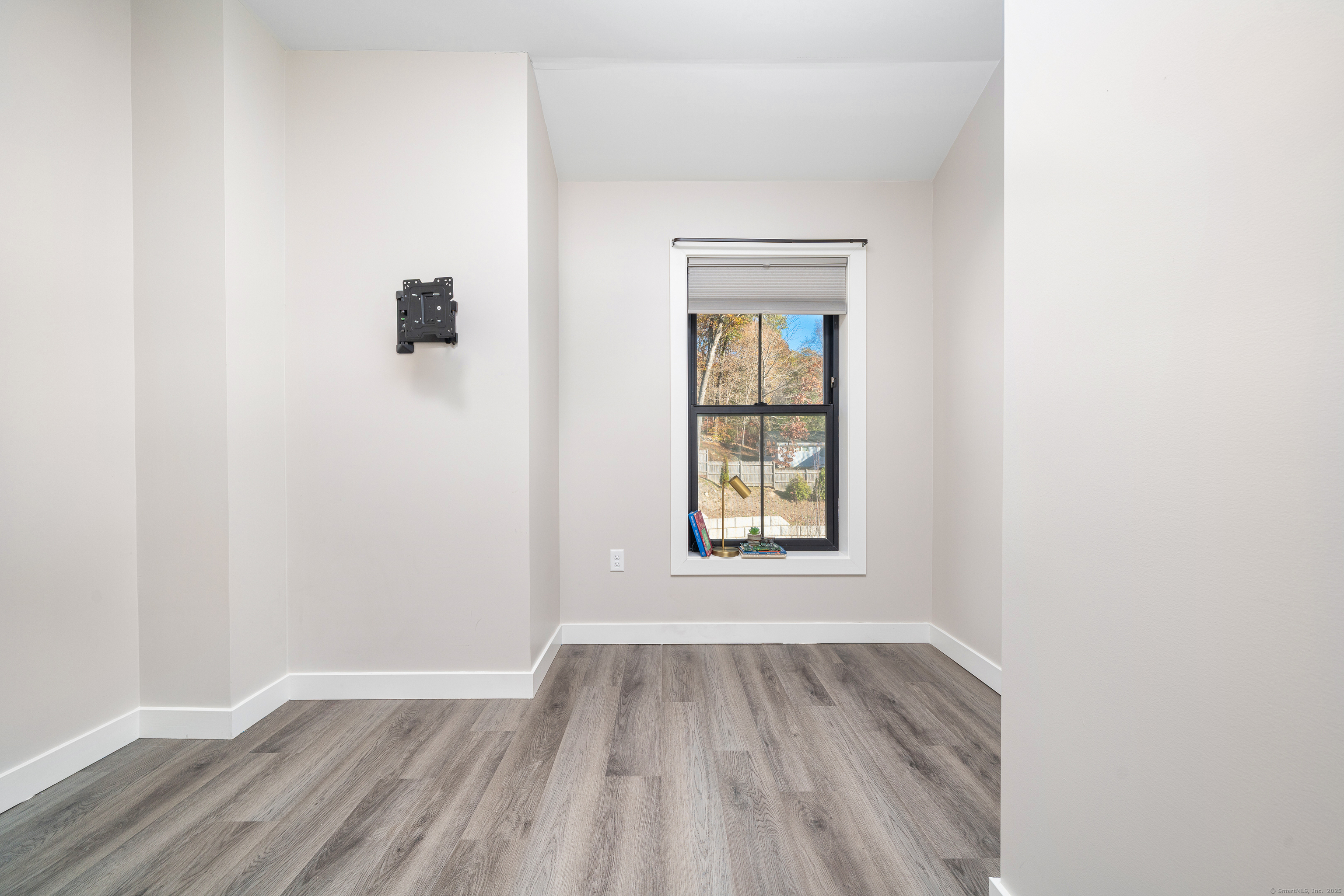 401 Albany Turnpike, Unit 201 Canton, CT 06019 - Photo 13 of 22 an empty room with wooden floor and windows