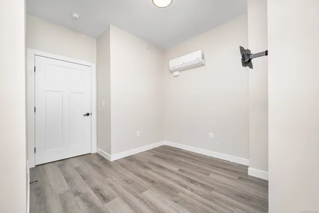 a view of a room with wooden floor