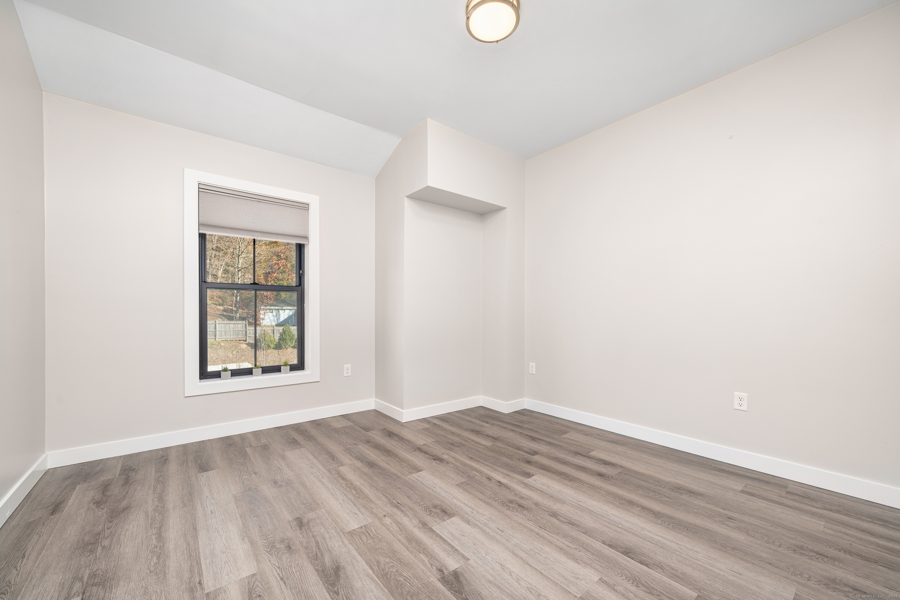 401 Albany Turnpike, Unit 201 Canton, CT 06019 - Photo 17 of 22 an empty room with wooden floor and windows