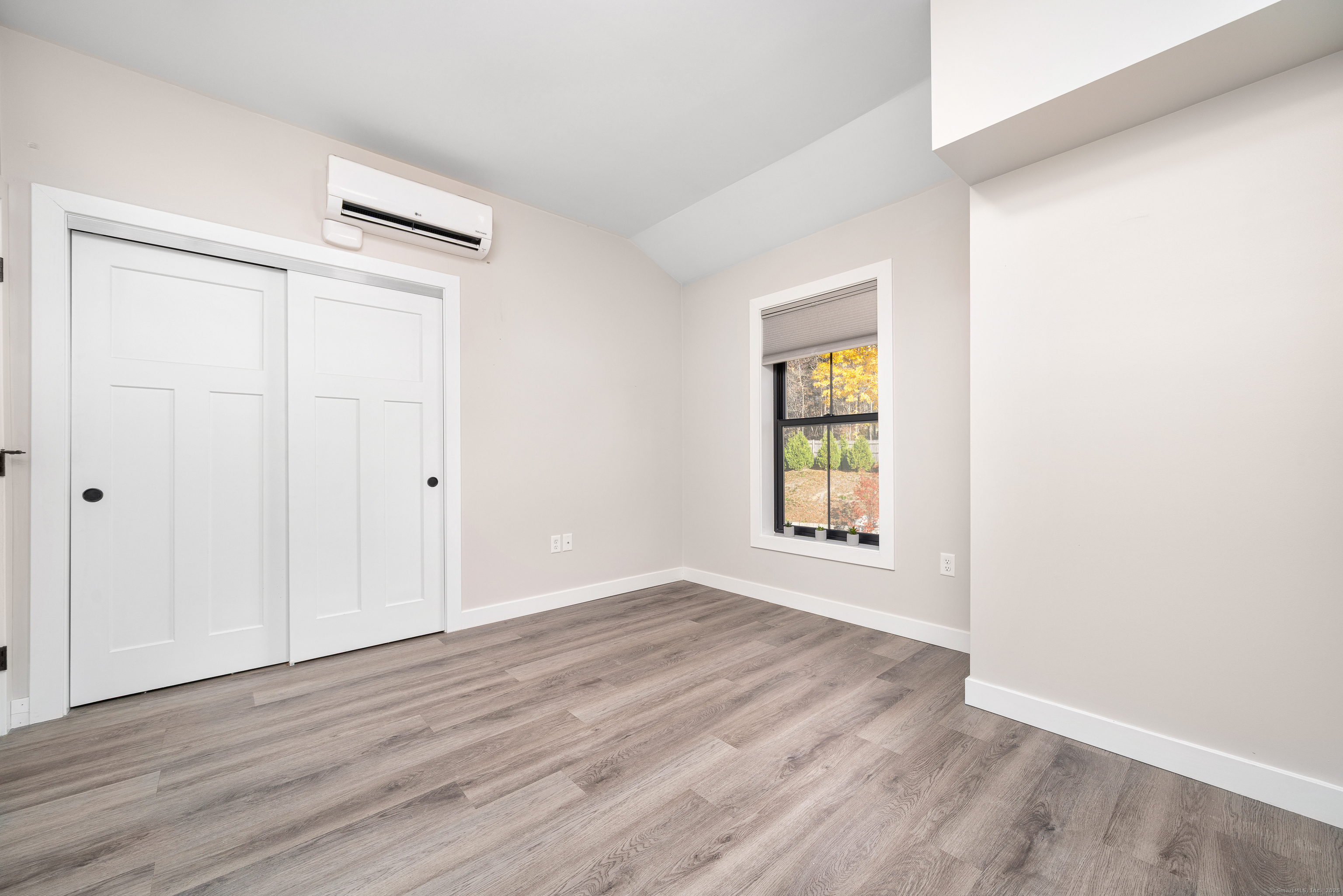 401 Albany Turnpike, Unit 201 Canton, CT 06019 - Photo 18 of 22 an empty room with wooden floor and windows