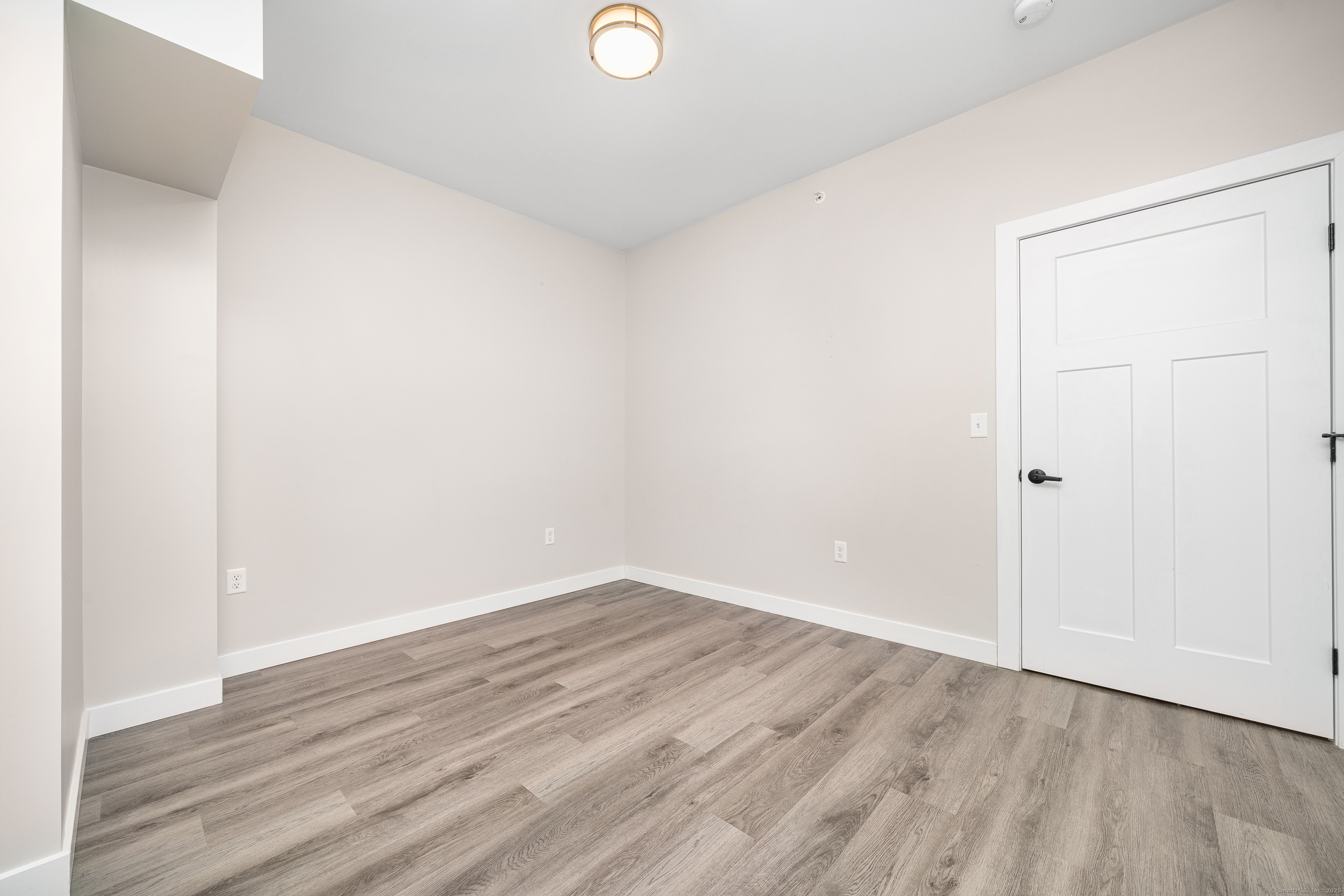 401 Albany Turnpike, Unit 201 Canton, CT 06019 - Photo 19 of 22 a view of an empty room with wooden floor