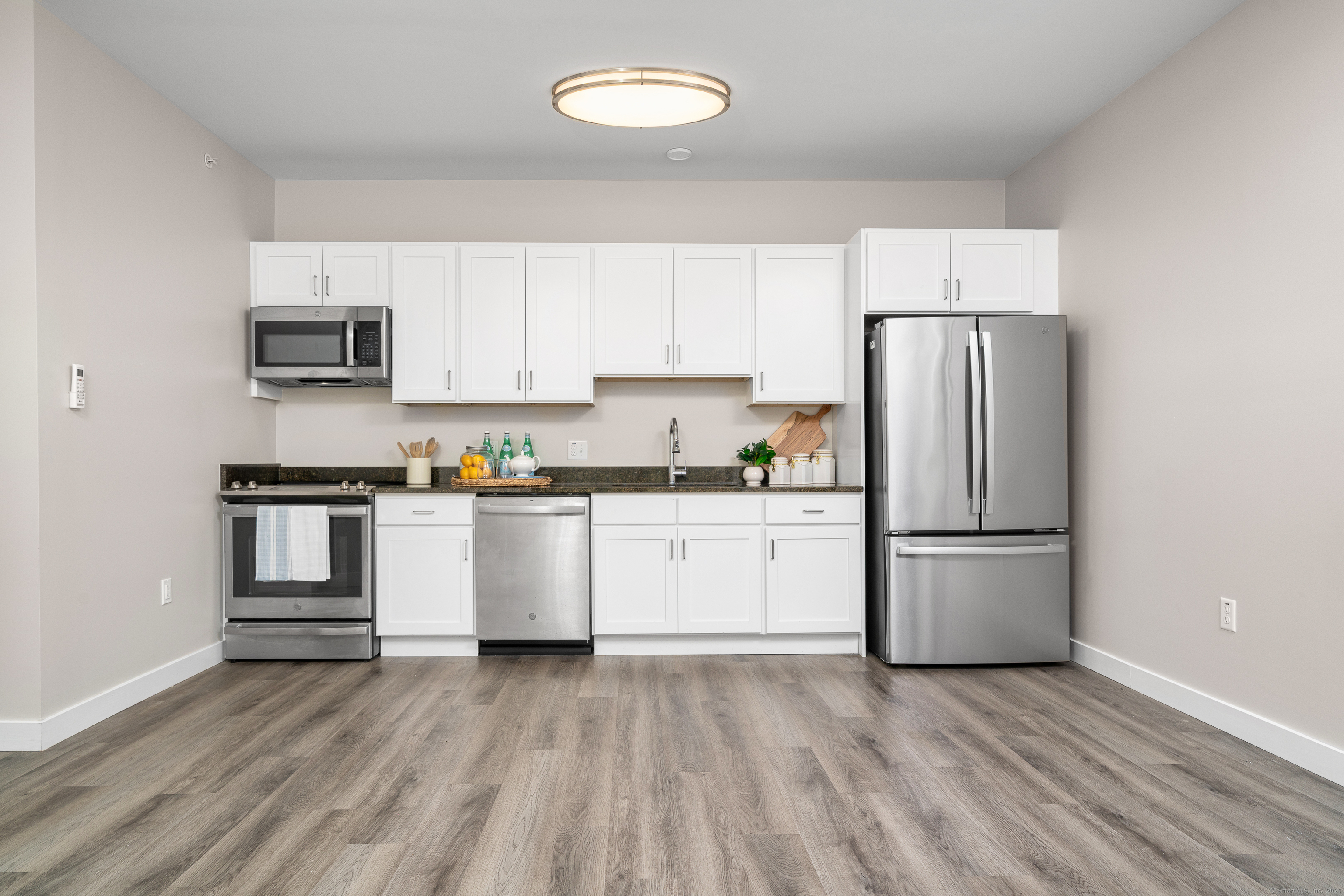 401 Albany Turnpike, Unit 201 Canton, CT 06019 - Photo 3 of 22 a kitchen with a refrigerator and white cabinets