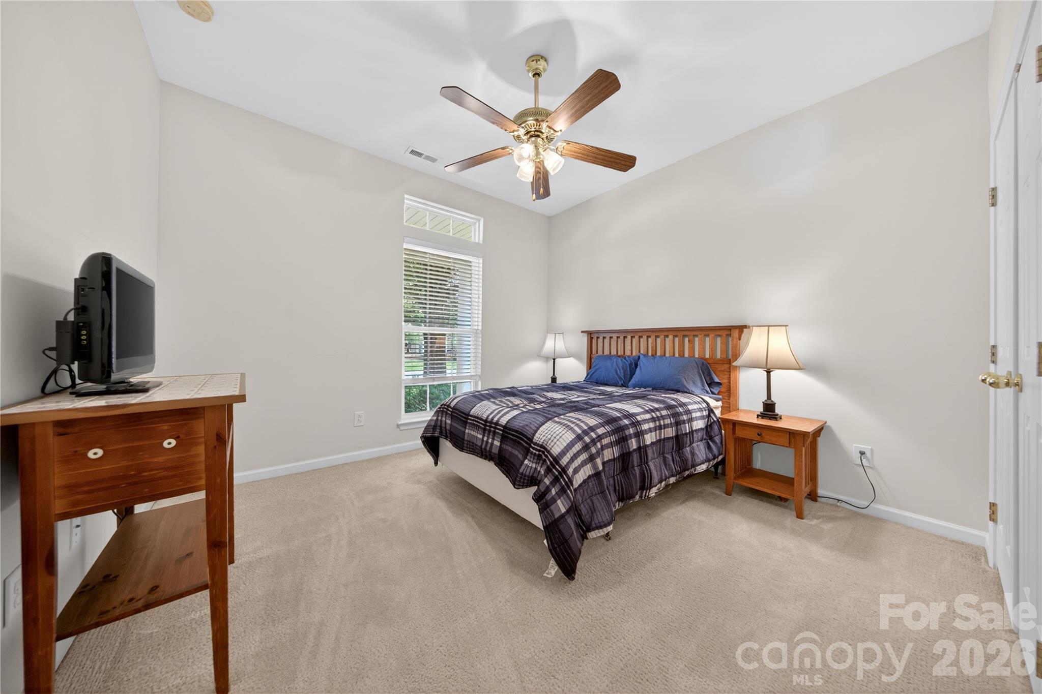 533 Fair Oaks Drive Fort Mill, SC 29708 - Photo 22 of 33 a bedroom with a large bed and a chandelier