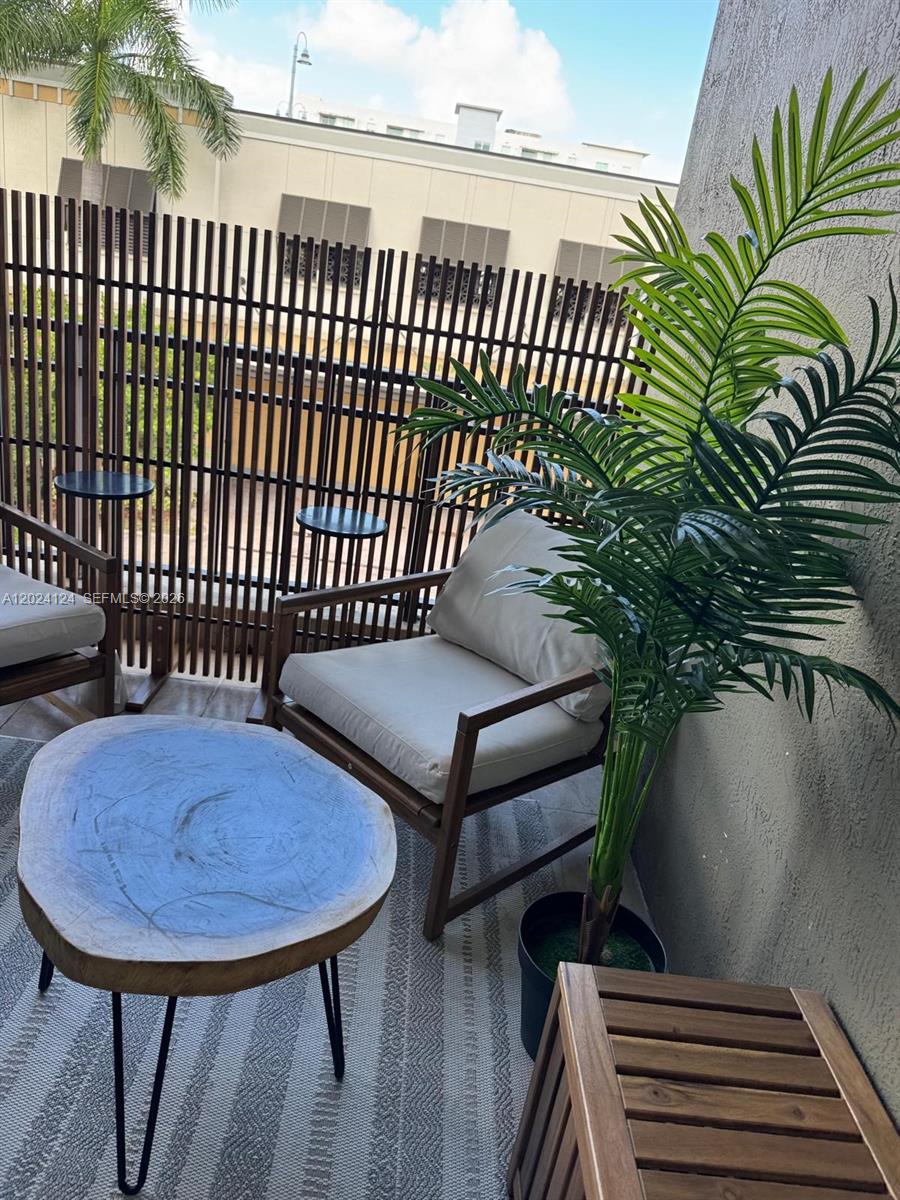 120 South Douglas Road, Unit 302 Miami, FL 33134 - Photo 23 of 28 a view of a chairs and table in patio