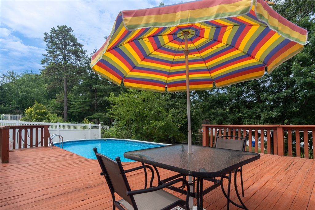 68 Sawmill Road Springfield, MA 01118 - Photo 17 of 25 a view of a roof deck with table and chairs a barbeque with wooden floor and fence