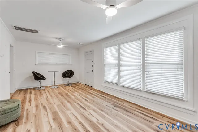 a view of a bedroom with a bed and a window