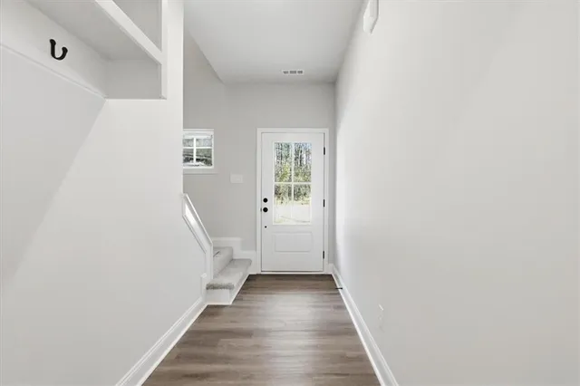 a view of a hallway with wooden floor