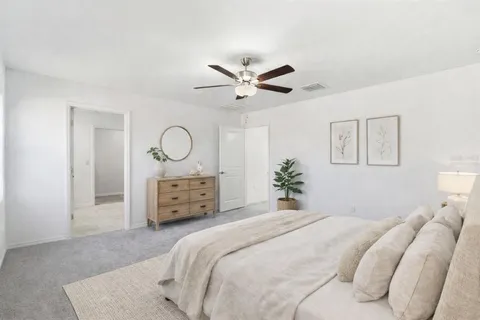 a bedroom with a bed chandelier and a window