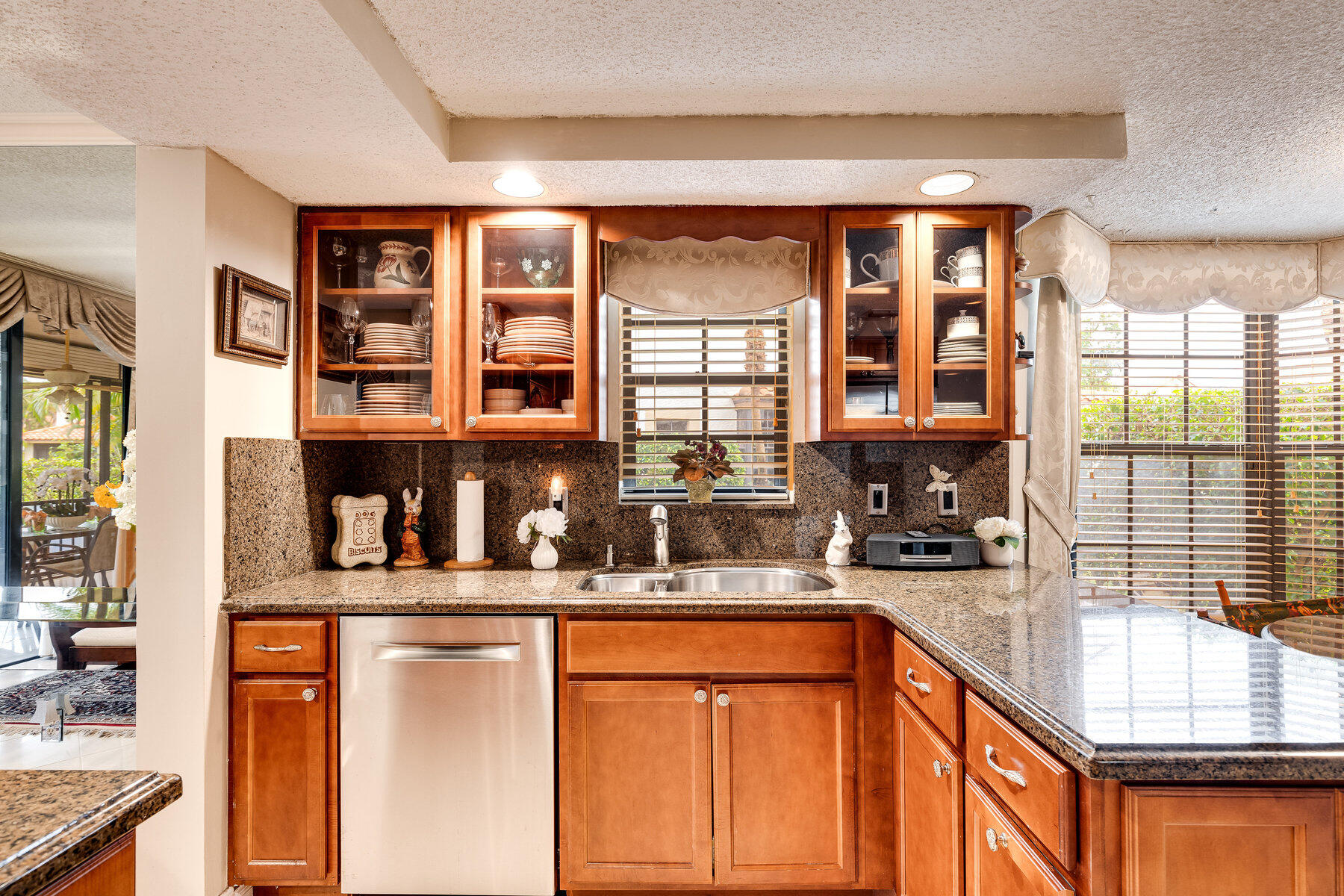7771 La Mirada Drive Boca Raton, FL 33433 - Photo 13 of 38 a kitchen with stainless steel appliances kitchen island granite countertop a refrigerator and cabinets