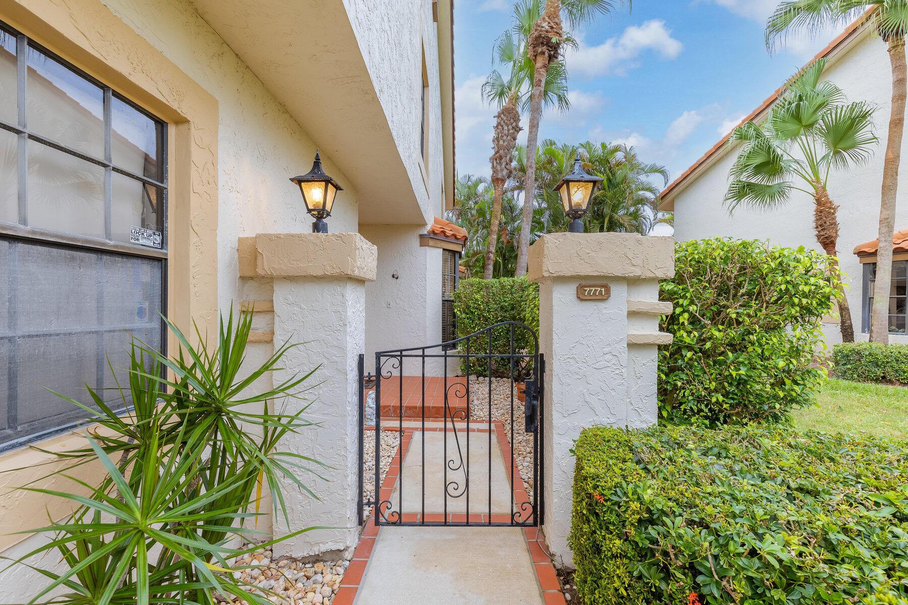 7771 La Mirada Drive Boca Raton, FL 33433 - Photo 3 of 38 a view of a house with a flower garden