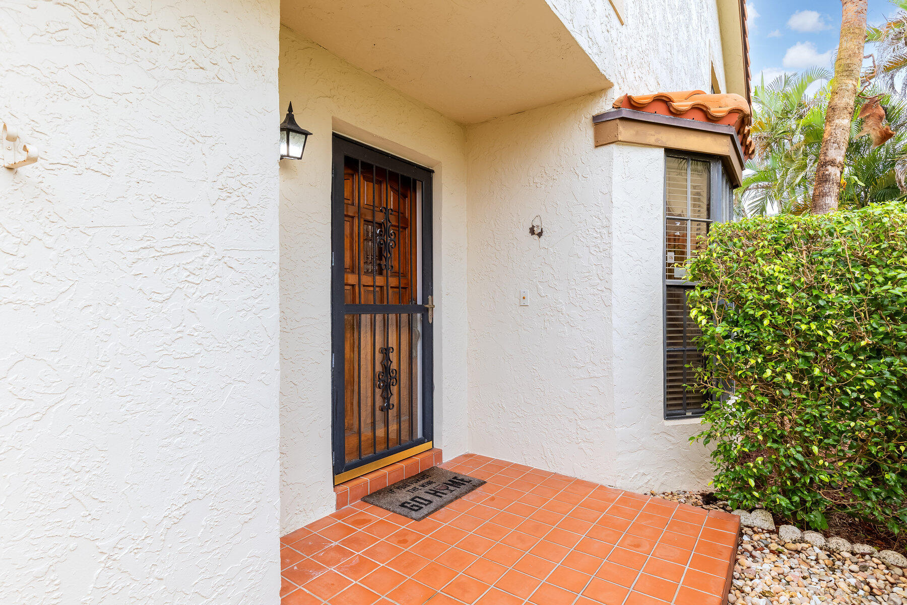 7771 La Mirada Drive Boca Raton, FL 33433 - Photo 4 of 38 a backyard of a house with potted plants