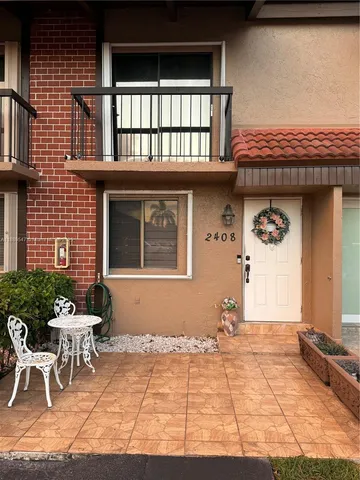 a front view of a house with outdoor seating
