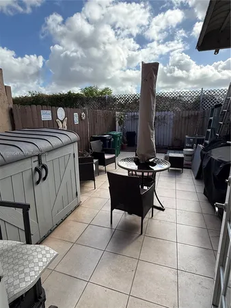 a view of a terrace with furniture and city view