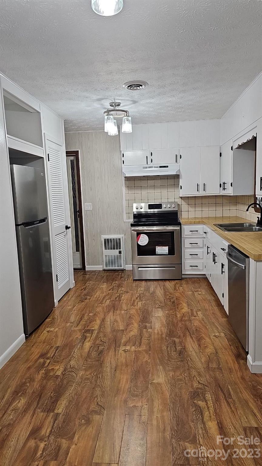 70 Letterman Road Green Mountain, NC 28740 - Photo 13 of 23 a kitchen with stainless steel appliances granite countertop a refrigerator a stove and a sink with cabinets