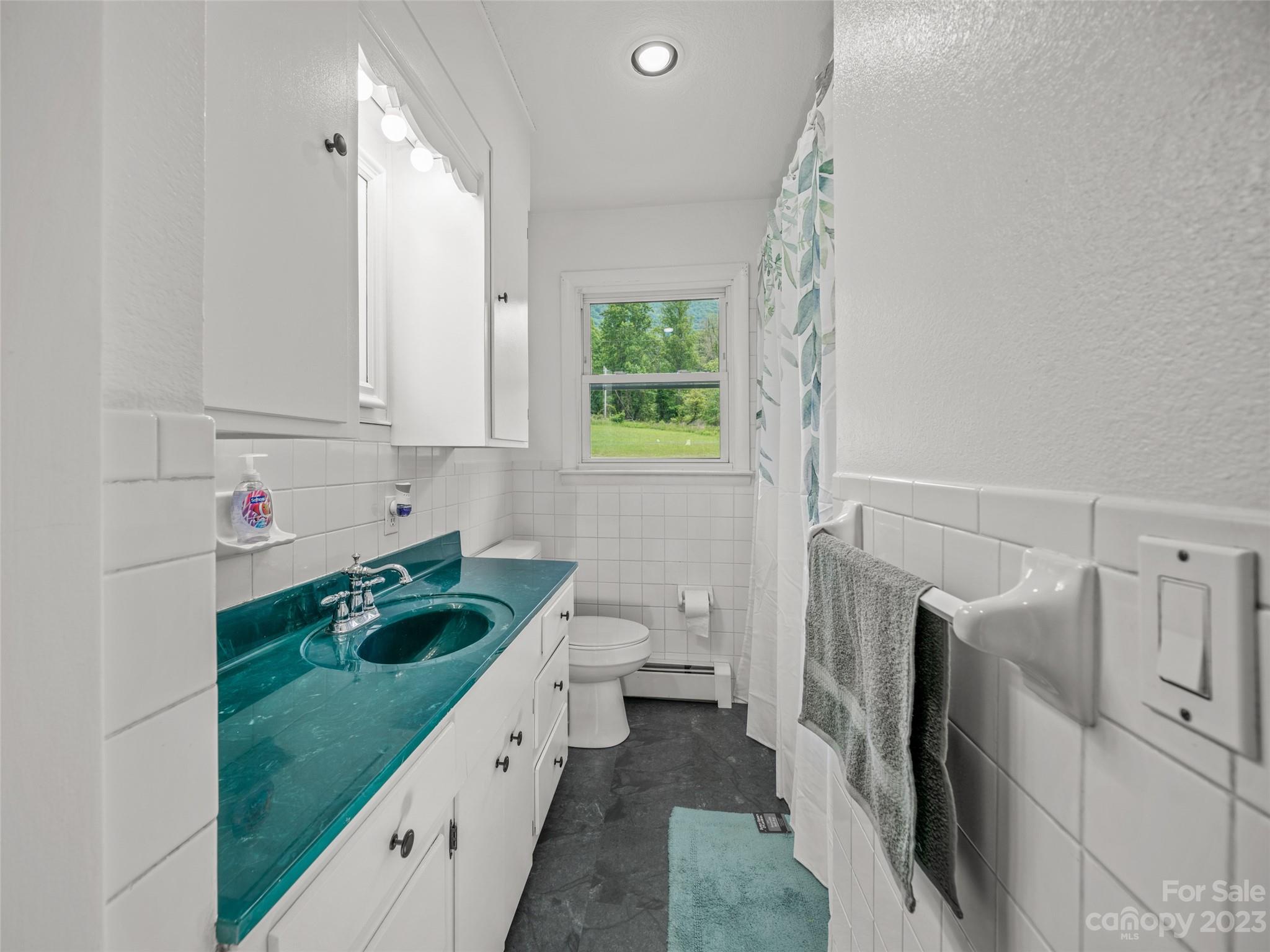 70 Letterman Road Green Mountain, NC 28740 - Photo 15 of 23 a bathroom with a granite countertop sink and a large mirror