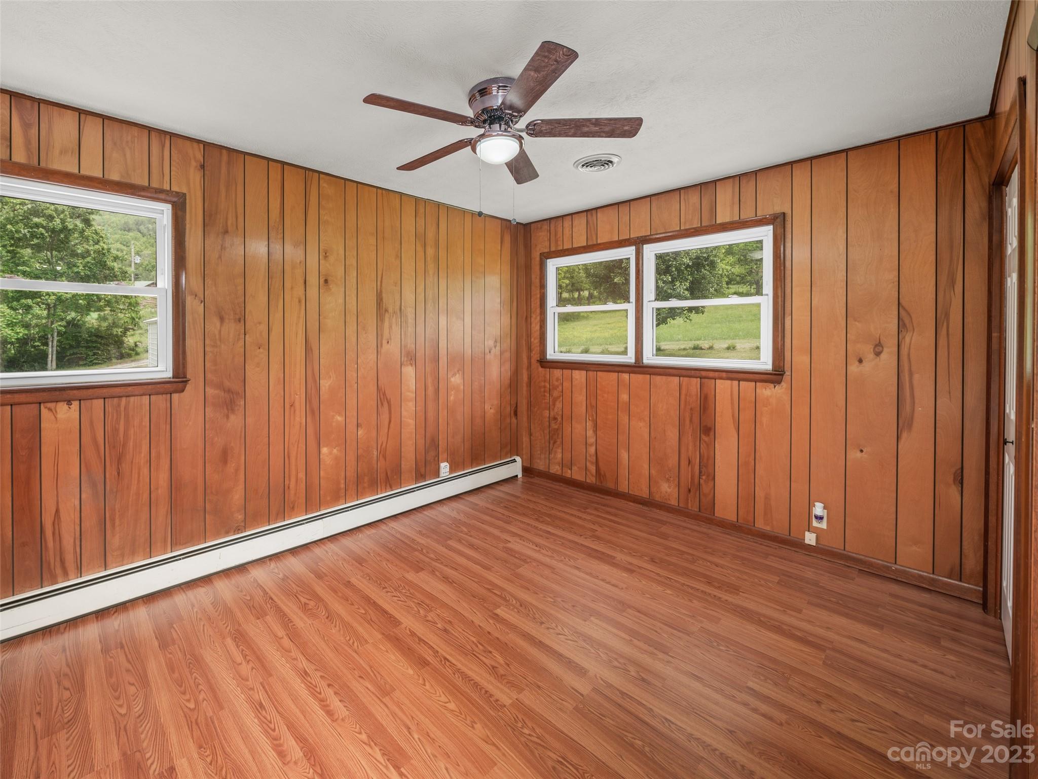 70 Letterman Road Green Mountain, NC 28740 - Photo 18 of 23 a view of an empty room with a window and wooden floor